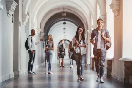 Students walking through marble halls on college campus